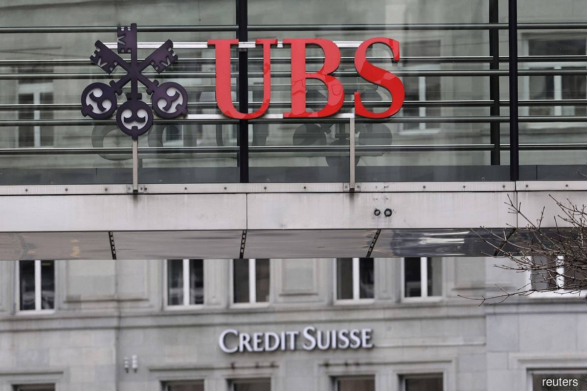 Logos of Swiss banks UBS and Credit Suisse are seen in Zurich March 19, 2023. (Reuters pic)